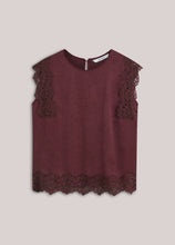 Load image into Gallery viewer, A sleeveless top in a deep burgundy color, featuring matching burgundy lace trim along the shoulder yokes and the scalloped hem, displayed against a solid light beige background.