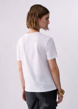 Load image into Gallery viewer, A woman with short brown hair is shown from the back wearing a plain white short-sleeve crewneck t-shirt and black pants, standing against a light gray studio background.
