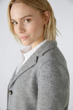 Load image into Gallery viewer, A woman with blonde hair wearing a gray wool-blend blazer over a white collared shirt, photographed against a light gray studio background.
