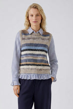 Load image into Gallery viewer, A model wearing a striped and textured knit sweater vest over a blue and white striped button-down shirt, paired with navy trousers, against a light gray studio background.
