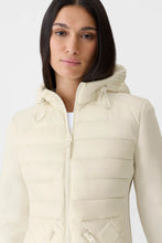 Load image into Gallery viewer, Woman wearing a beige quilted jacket on a white background
