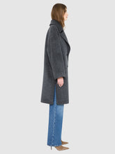 Load image into Gallery viewer, A woman shown in side profile wearing a dark gray wool-blend coat over blue wide-leg jeans and tan pointed-toe heels, photographed against a light gray studio background.
