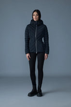 Load image into Gallery viewer, Woman wearing a black quilted jacket against a gray background
