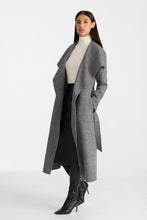 Load image into Gallery viewer, A woman modeling a long gray textured open-front coat over a white turtleneck, black skirt, and black pointed-toe heeled boots, photographed against a clean light gray studio background.
